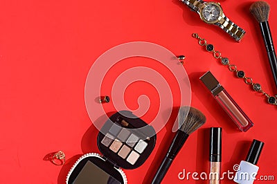 Blogging Beauty Concept. Professional women`s cosmetics, accessories, watches, bracelet. Female ideas and background. Red Stock Photo