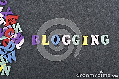 BLOGGING word on black board background composed from colorful abc alphabet block wooden letters, copy space for ad text Stock Photo