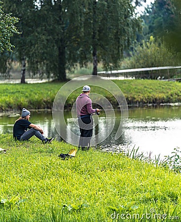 Blome / Latvia - August 20th, 2018: Photo of Two Millennials Fishing - Spending Quality Leisure Time Editorial Stock Photo