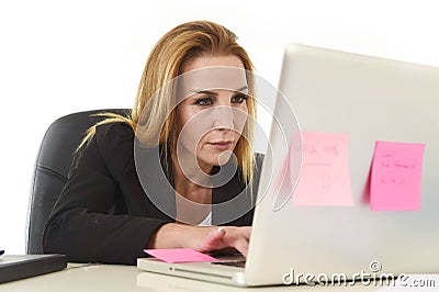 Blond attractive 40s woman in business suit working at laptop computer Stock Photo
