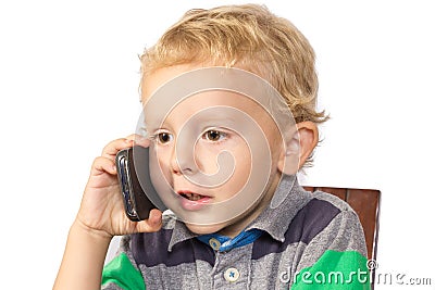 Blond boy careful talking on a cell phone Stock Photo