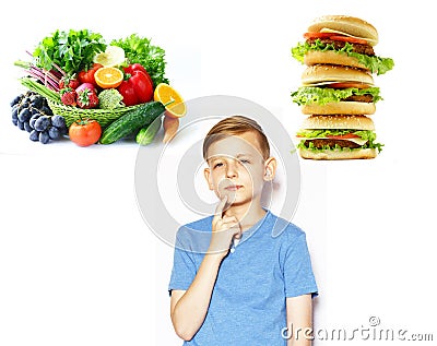 Boy chooses between healthy food and fast food Stock Photo