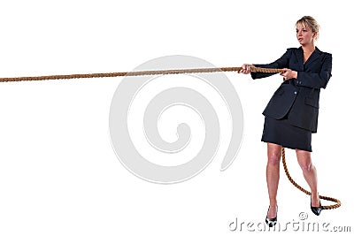 Blond businesswoman pulling on rope Stock Photo