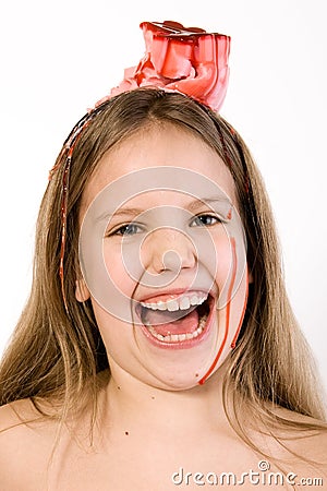 Blond child with desert on her head laughing Stock Photo