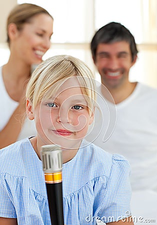 Blond child singing with a microphone Stock Photo