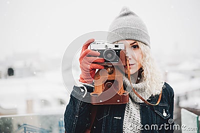 Blond curly girl with film photo camera, winter Stock Photo