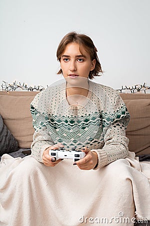 Blond european girl playing video games in her home Stock Photo