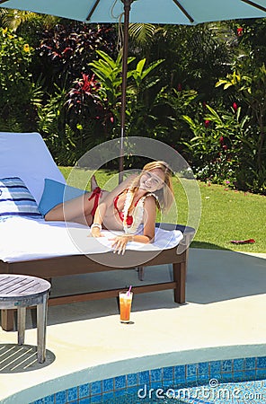 Blond girl in bikini at a swimming pool Stock Photo