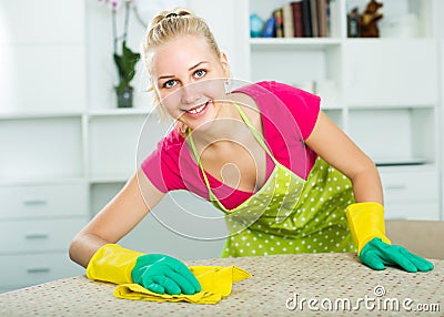 Blond girl cleaning surfaces at home Stock Photo