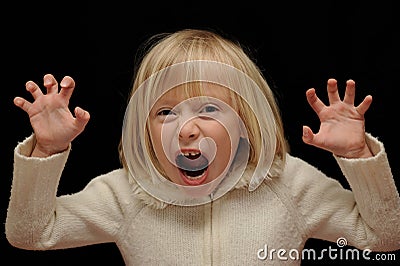 Blond girl making scary face Stock Photo