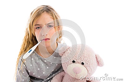 Blond girl with thermometer and flu cold in pyjama Stock Photo