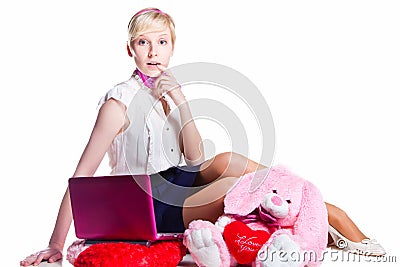 Blond girl working with pink laptop Stock Photo