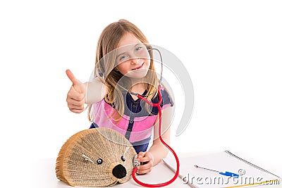 Blond kid girl pretending be doctor with hedgehog Stock Photo