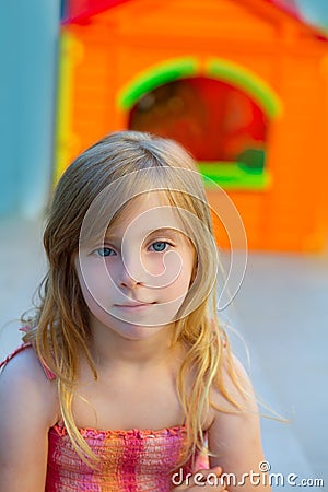 Blond kid girl smiling in outdoor playground Stock Photo
