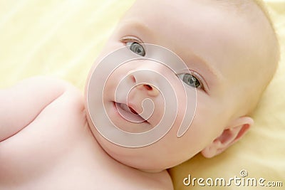 Blond little baby laying on bed portrait Stock Photo