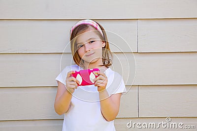 Blond little fashion kid girl playing with smartphone Stock Photo