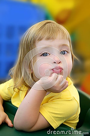 Blond little girl funny expression in her mouth Stock Photo