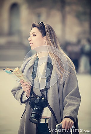 Blond positive girl holding brochure in hands Stock Photo