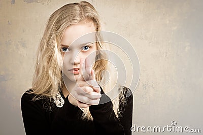 Blond Teenage Girl Pointing Finger Gun At The Camera Stock Photo