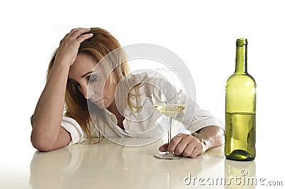 Blond wasted and depressed alcoholic drunk woman drinking white wine glass desperate sad Stock Photo