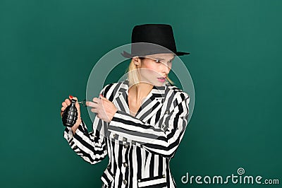 Blond woman activating a hand grenade Stock Photo