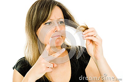 Blond woman - housewife - having problem with long straight hairs - hair cut needed Stock Photo