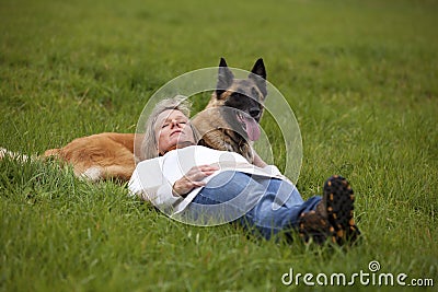 Blond woman relaxing with her dog Stock Photo