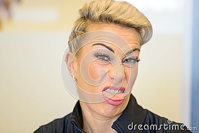 Blond woman showing her disgust and aversion Stock Photo