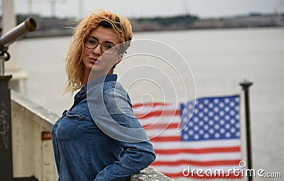 Blond woman siting near the river Stock Photo