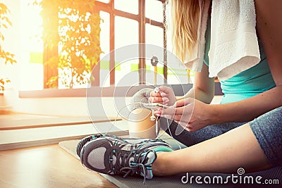 Blond woman with smart phone, resting after gym workout Stock Photo