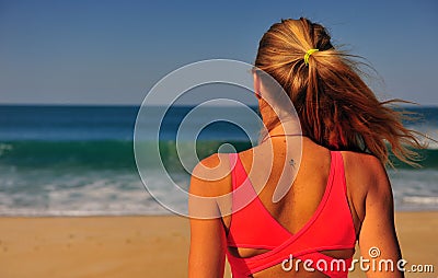 Blond woman standing at sea Stock Photo