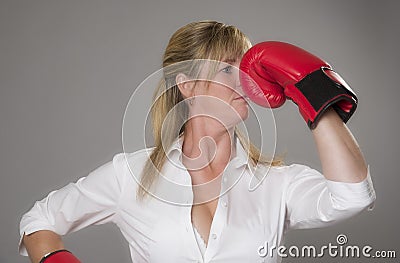 Blond woman wearing red boxing gloves Stock Photo