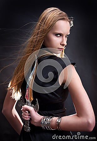 Blond young girl holding dagger Stock Photo