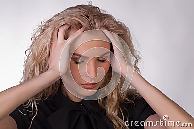 Blond young woman with a headache Stock Photo