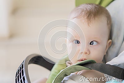 Blonde baby girl sitting in the stroller Stock Photo