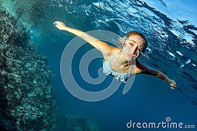 Blonde beautiful Mermaid diver underwater Stock Photo
