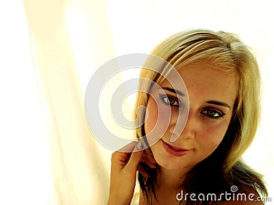 Blonde, black ombre haired and blue eyed young woman with cream-colored texture background. Stock Photo