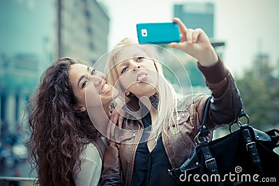 Blonde and brunette beautiful stylish young women Stock Photo