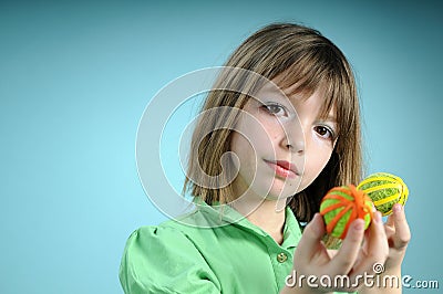 Blonde child showing easter ornaments Stock Photo