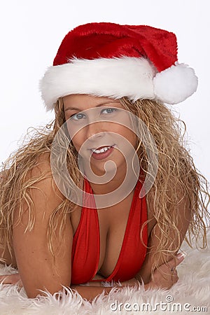 Blonde Female Santa in Red Bikini Lying on Fur Rug Stock Photo