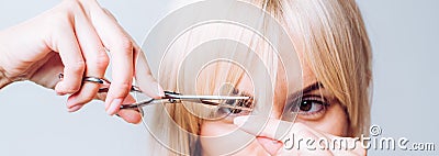 Blonde girl cut forelock. Close up hairstyle with bangs. Hair care concept. Stock Photo