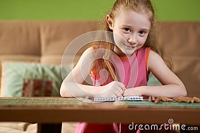 Blonde girl draws pencils Stock Photo