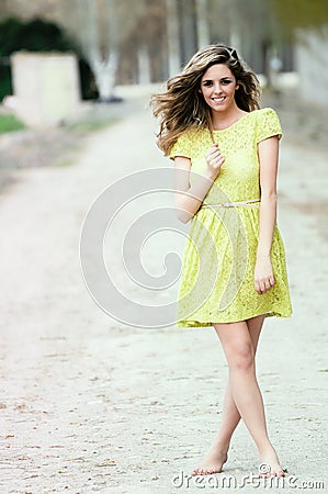 Blonde girl standing in rural road Stock Photo