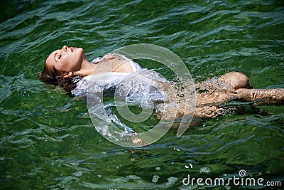 Blonde girl swimming and having fun on the beach on blue sea in summer. Sensual young woman in sea. Woman on tropical Stock Photo