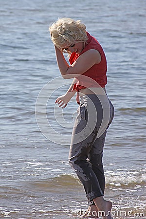Blonde haired young woman at the beach Stock Photo