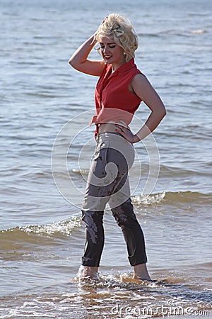 Blonde haired young woman at the beach Stock Photo