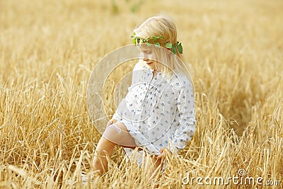 Blonde little girl in the field Stock Photo