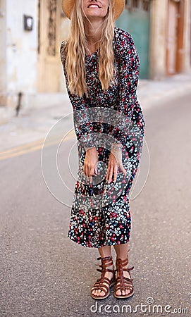 Blonde Mediterranean woman floral pattern dress posing concept Stock Photo