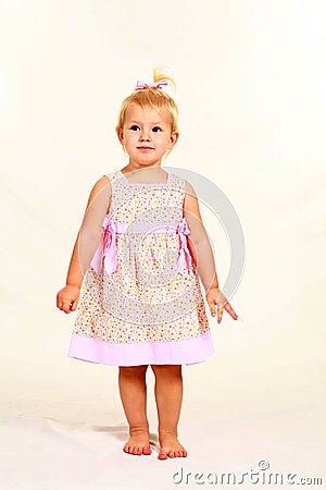 Blonde toddler girl in floral dress Stock Photo