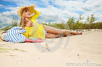 Blonde wearing sun hat at the beach Stock Photo